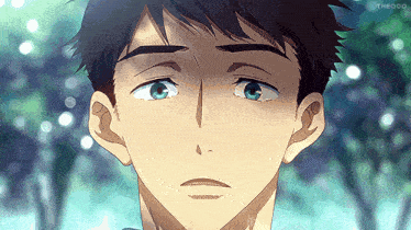 a close up of a man 's face with blue eyes