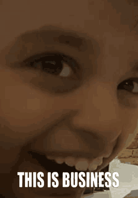 a close up of a person 's face with the words `` this is business '' written on it .