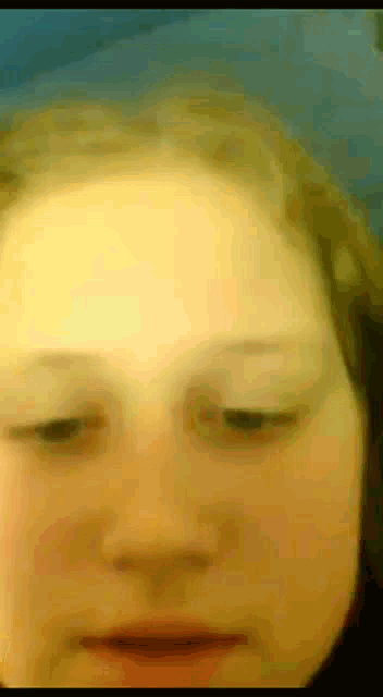 a close up of a person 's face with a blue background
