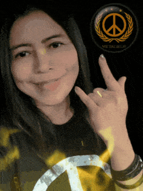 a woman wearing a metalieur shirt shows a peace sign