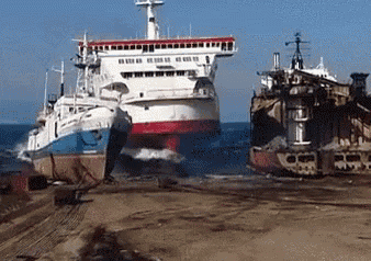 a large ship is sitting on top of a sandy beach next to a smaller ship