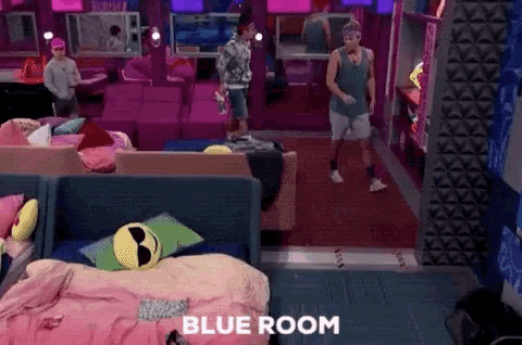 two men are standing in a room with the word blue room written on the floor