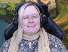 a woman wearing headphones is sitting in a chair .