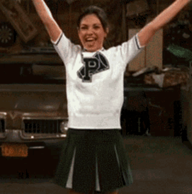 a woman wearing a white shirt with a letter p on it