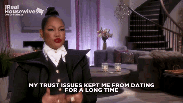 a woman is sitting in a living room talking about her trust issues