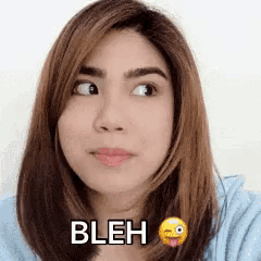 a close up of a woman 's face with the word bleh written on it