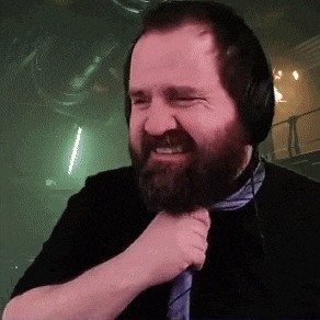 a man with a beard wearing headphones and a tie .
