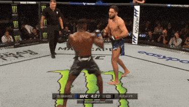 two men are fighting in a boxing ring with a monster on the ground