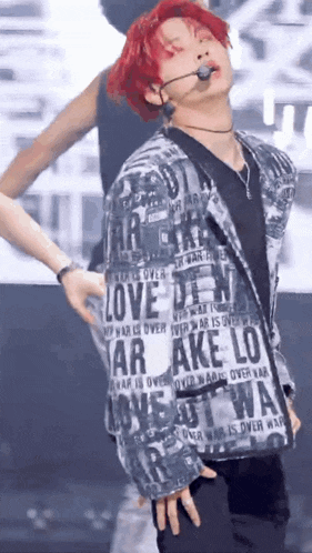 a man with red hair and a jacket that says love on it