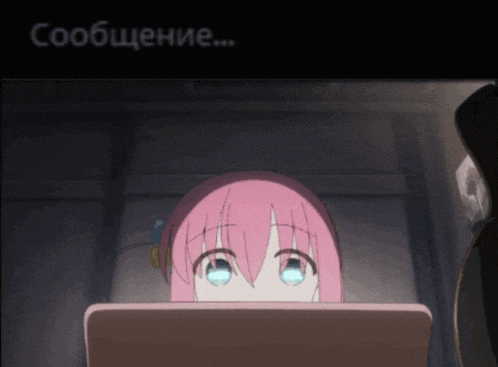 a girl with pink hair and blue eyes is sitting in front of a laptop computer