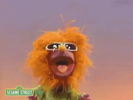 elmo and kermit from sesame street standing next to each other