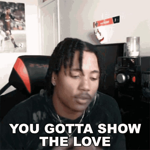 a man with dreadlocks is sitting in a chair with the words you gotta show the love above him