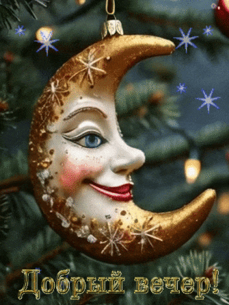a crescent moon with a face on it is hanging on a christmas tree branch