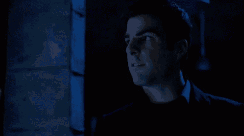 a man in a black shirt is looking up at something