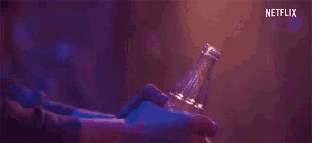 a close up of a person 's hand holding a bottle of water .