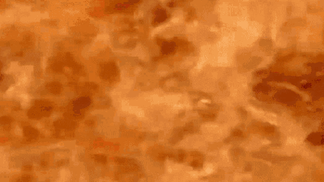 a close up of a fire texture with a few spots of white