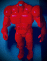 a red robot with a blue background is standing in the dark
