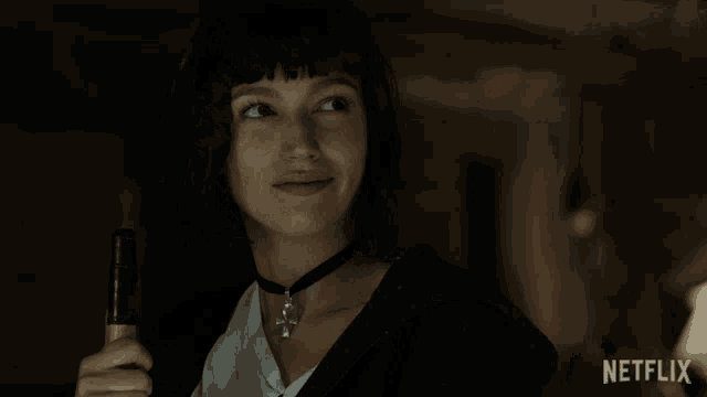 a woman is smiling and holding a bottle of beer with a netflix logo in the corner