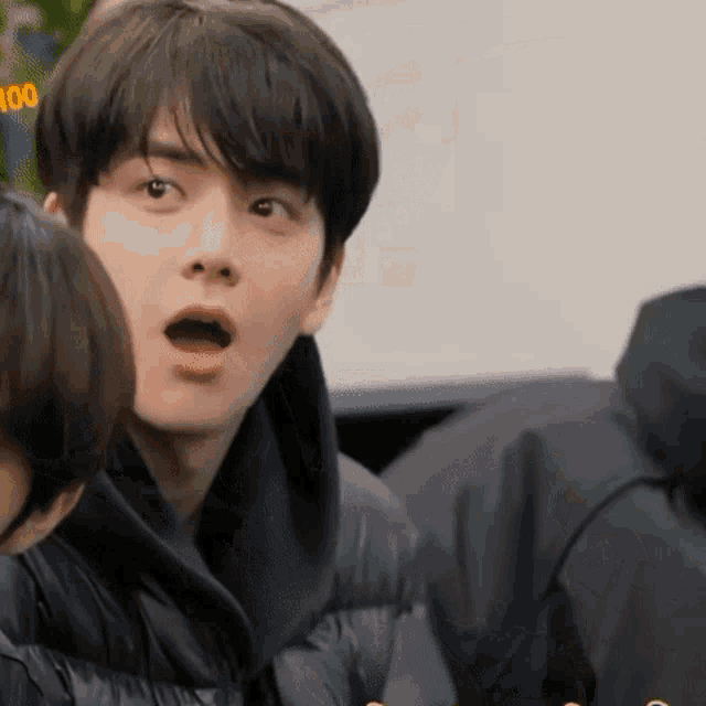 a close up of a person 's face with a surprised look on his face .