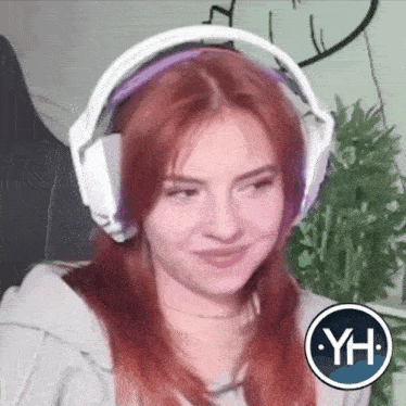 a girl with red hair wearing headphones with the letters yh on the bottom