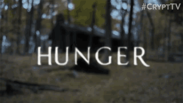 a person 's hand is touching the word hunger