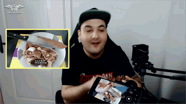 a man in a black shirt with the word jordan on it looks at a plate of food