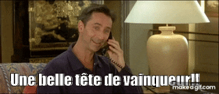 a man is sitting on a couch talking on a phone with the words une belle tete de vainqueur