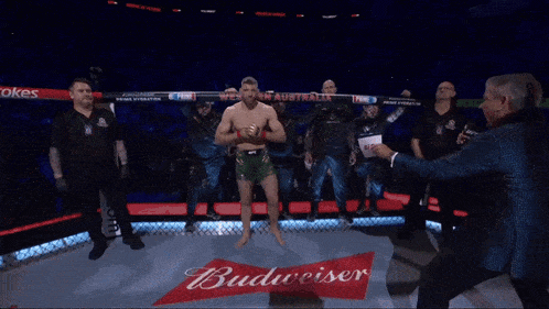 a man in a boxing ring holds a sign that says western australia
