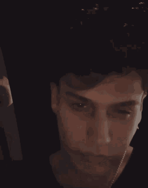 a close up of a young man 's face with his eyes closed and his mouth open .