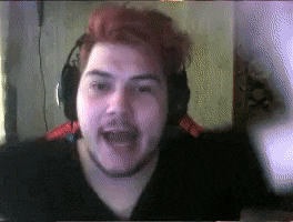 a man with red hair is wearing headphones and a beard