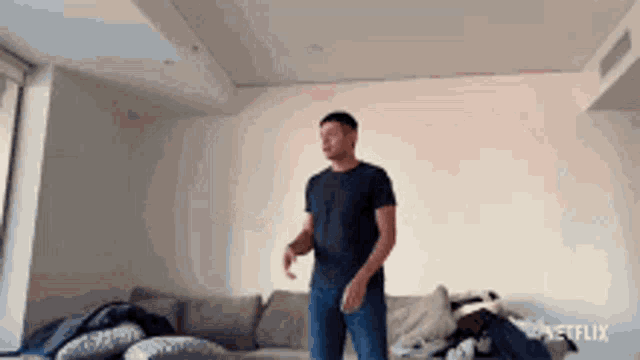 a man is dancing in a living room with a netflix logo in the corner