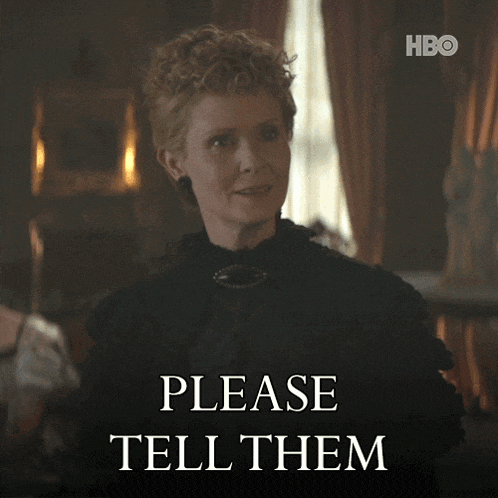 a woman in a black dress stands in front of a sign which says please tell them