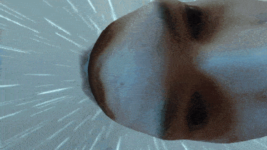a close up of a person 's face with a light behind it