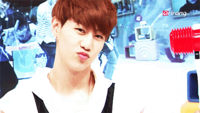 a young man making a face with arirang written on the bottom right