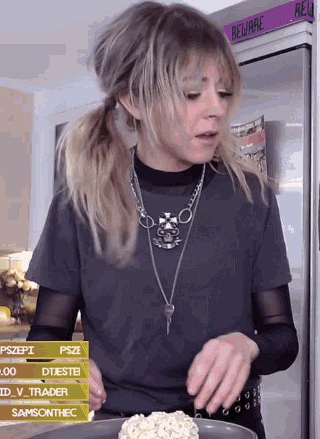 a woman cooking in front of a refrigerator that has the word beware on it