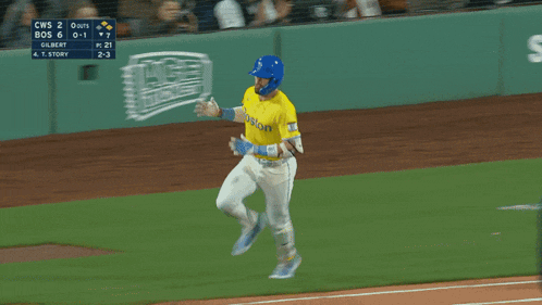 a baseball player wearing a yellow jersey that says boston on it