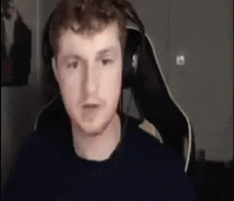 a man wearing headphones is sitting in front of a computer screen .