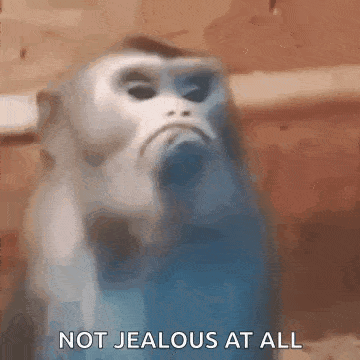 a blurry picture of a monkey with the words `` not jealous at all '' written on it .
