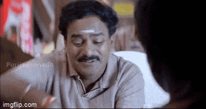 a man with a mustache is sitting in front of a woman .