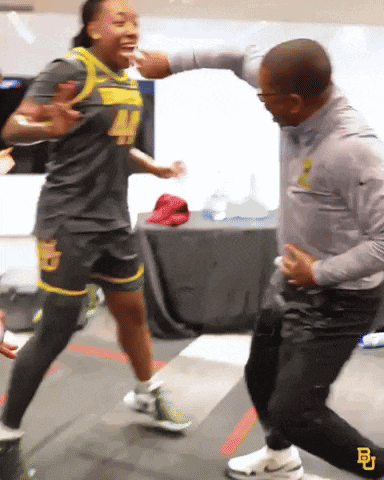 a man and a woman are dancing and the man is wearing a nike shirt