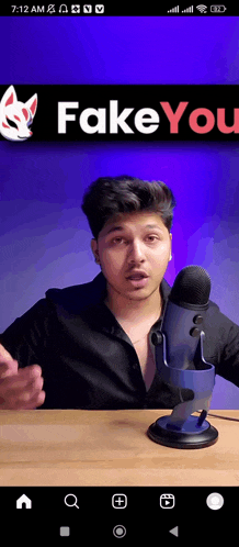 a man is sitting in front of a microphone with fake you written on the bottom