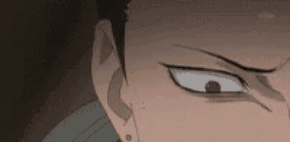 a close up of a man 's face with a piercing in his ear and a serious look on his face .