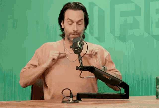a man sitting in front of a microphone with the word ufc on the wall