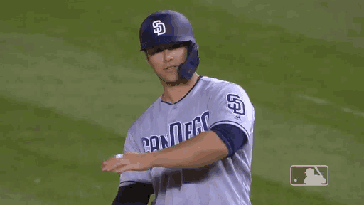 a baseball player wearing a san diego jersey gives a thumbs up