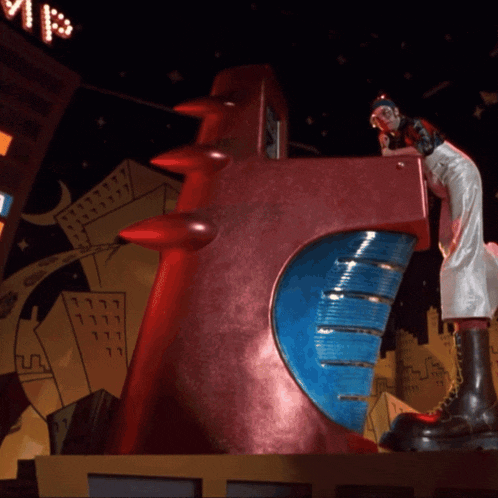 a statue of a woman standing on top of a red object with a blue circle in the middle