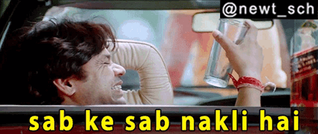 a man in a car holding a glass with the words sab ke sab nakli hai above him