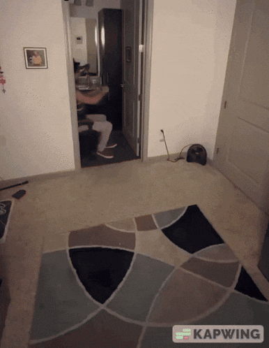a room with a rug and the word kapwing on the floor