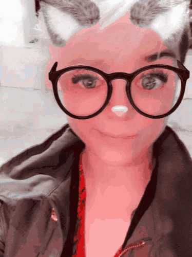 a woman wearing cat ears and glasses looks like a cat