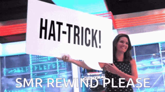 a woman is holding a sign that says hat-trick