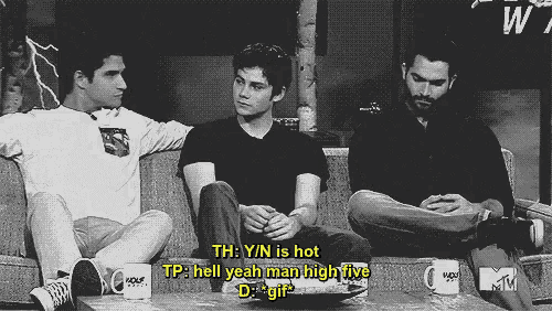three men are sitting on a couch with one saying th y n is hot tp hell yeah man high five d gif